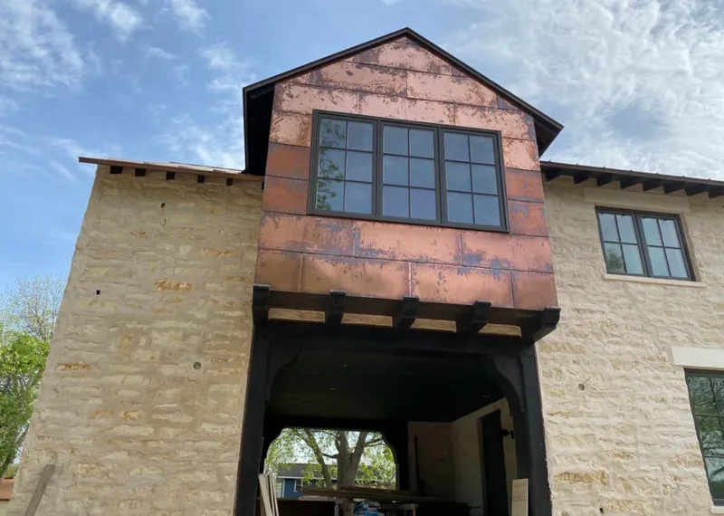 Copper metal panel facade on a stone building for Roof Repair in Travelers Rest